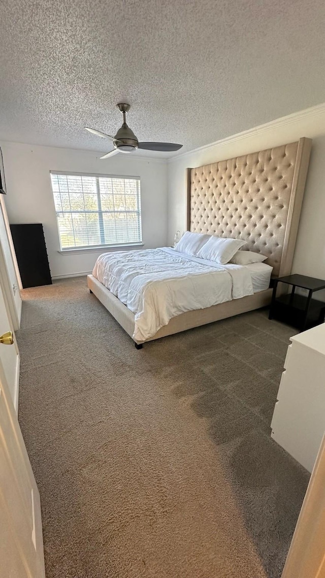 bedroom with ceiling fan, a textured ceiling, and dark carpet