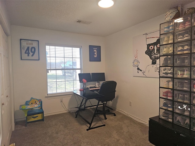 carpeted home office with visible vents, a textured ceiling, and baseboards