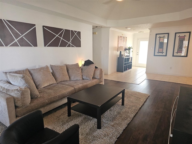 living room featuring ornamental molding, wood finished floors, and baseboards