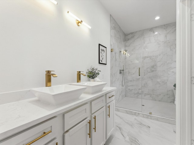 bathroom with marble finish floor, a marble finish shower, a sink, and recessed lighting