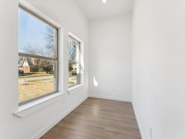 empty room featuring baseboards and wood finished floors