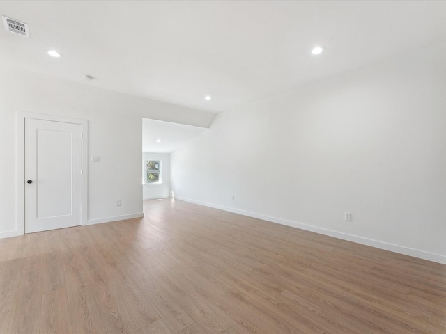 spare room featuring recessed lighting, baseboards, visible vents, and light wood finished floors