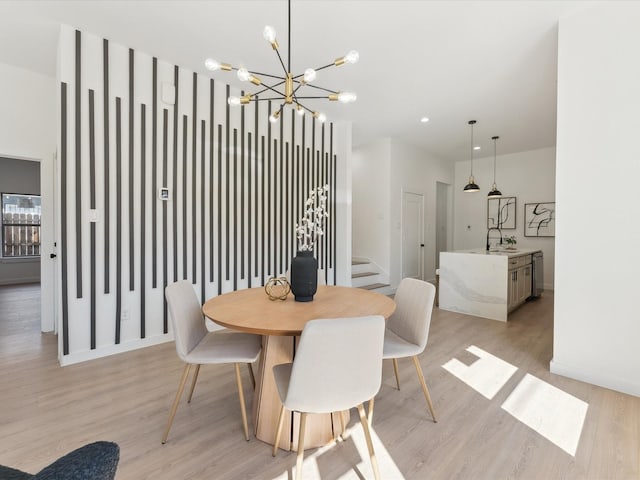 dining area with light wood finished floors, baseboards, stairway, a chandelier, and recessed lighting