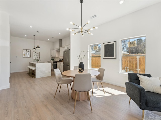 dining room with light wood-style flooring, visible vents, baseboards, and recessed lighting