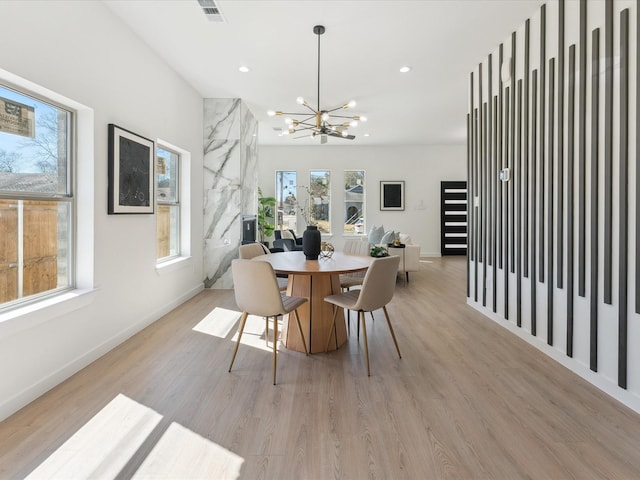 dining area featuring a chandelier, light wood finished floors, visible vents, and recessed lighting