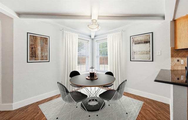 dining room featuring baseboards and dark wood finished floors