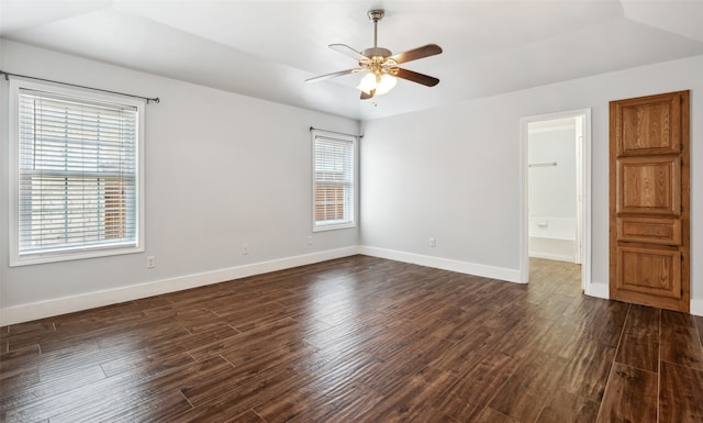 unfurnished room featuring ceiling fan, dark wood finished floors, and baseboards