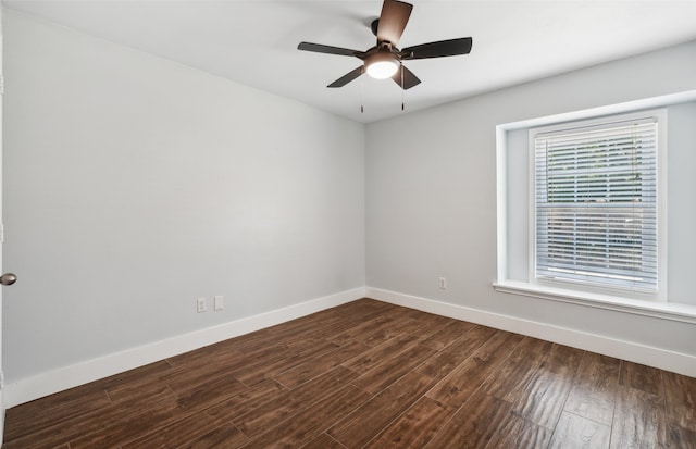 empty room featuring dark wood-style floors, ceiling fan, and baseboards