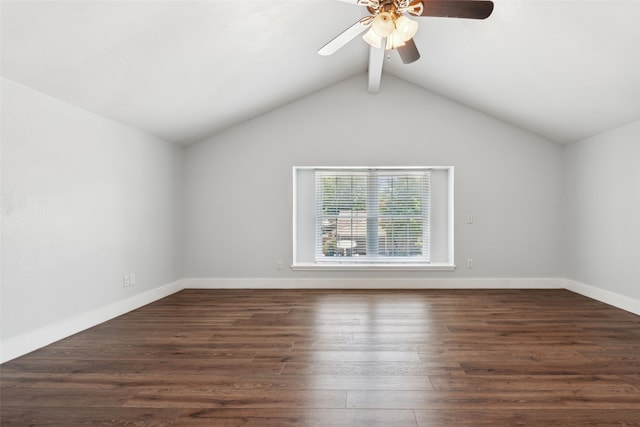 unfurnished room featuring dark wood-type flooring, lofted ceiling with beams, baseboards, and a ceiling fan