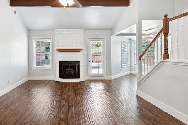 unfurnished living room featuring vaulted ceiling with beams, baseboards, stairway, and dark wood finished floors