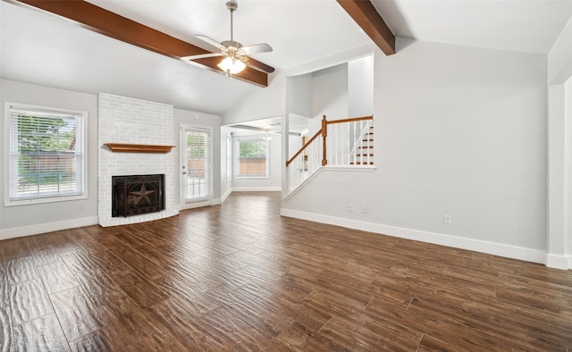 unfurnished living room featuring dark wood-style floors, plenty of natural light, baseboards, and stairs