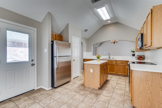 kitchen with lofted ceiling, a center island, stainless steel appliances, light countertops, and a sink