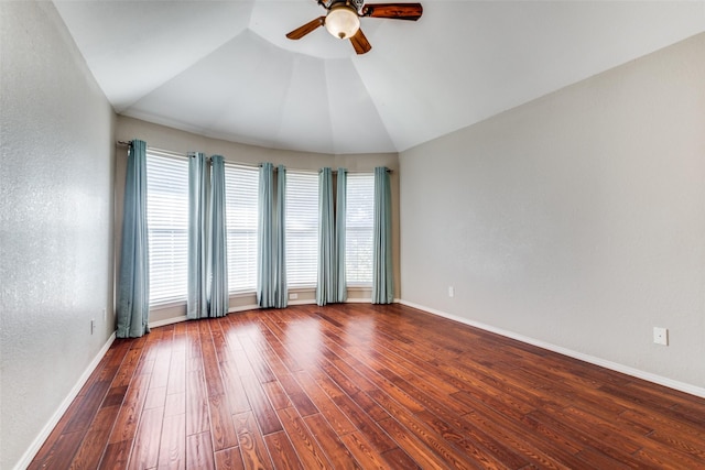 unfurnished room with baseboards, a textured wall, lofted ceiling, ceiling fan, and wood finished floors