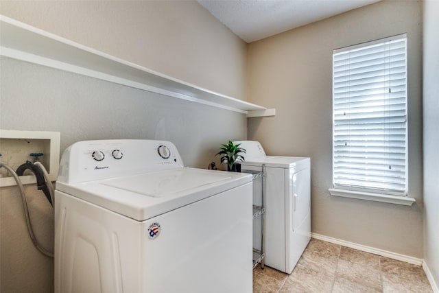 laundry room featuring laundry area, baseboards, and washer and clothes dryer