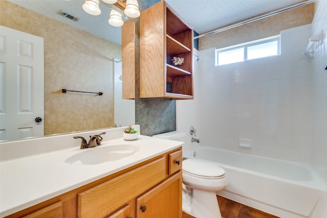 bathroom featuring visible vents, toilet, a textured ceiling, vanity, and shower / washtub combination