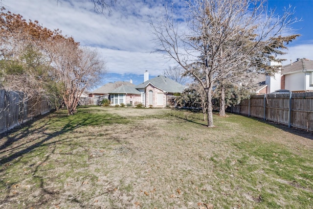 view of yard with a fenced backyard