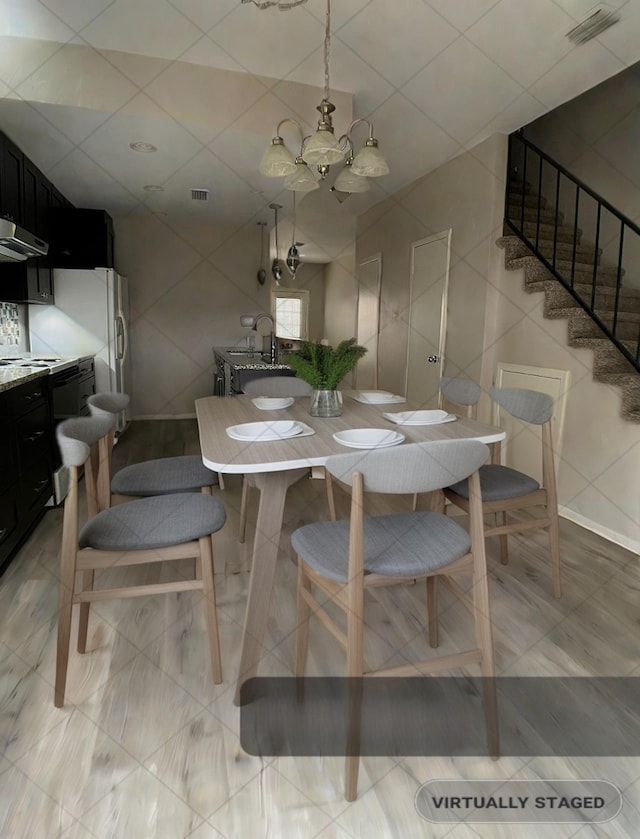 dining room with stairway, tile walls, visible vents, and an inviting chandelier