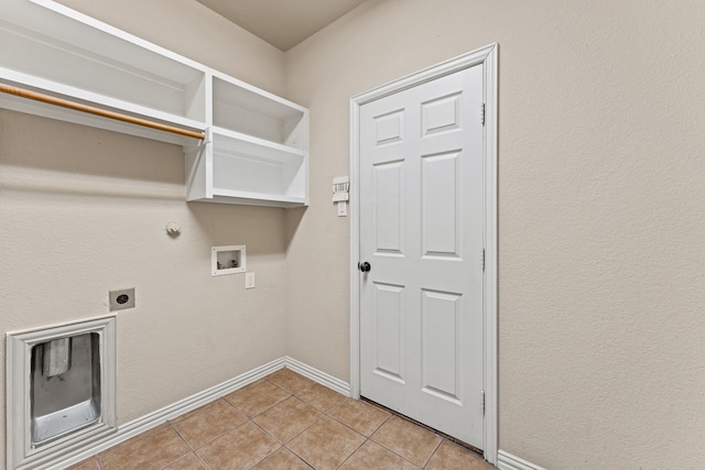 washroom with laundry area, baseboards, hookup for an electric dryer, washer hookup, and light tile patterned flooring