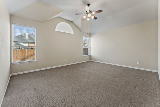 unfurnished room with carpet, baseboards, vaulted ceiling, and a ceiling fan