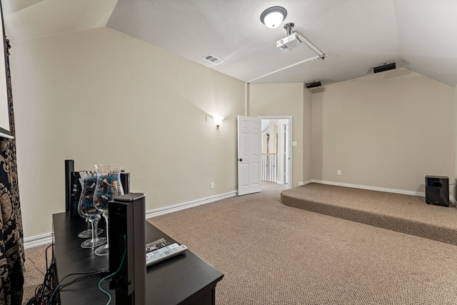 interior space featuring vaulted ceiling, visible vents, and baseboards