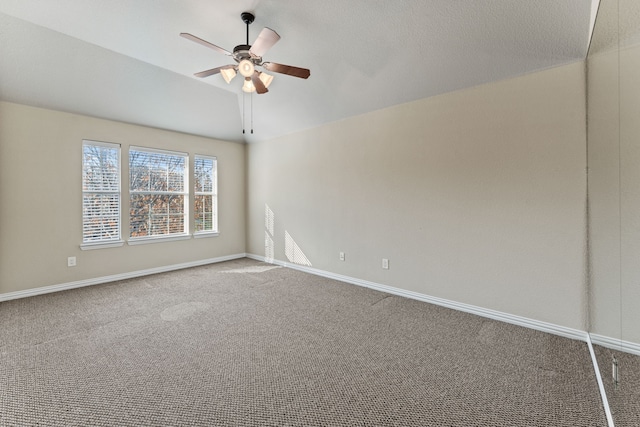 empty room featuring carpet floors, ceiling fan, and baseboards