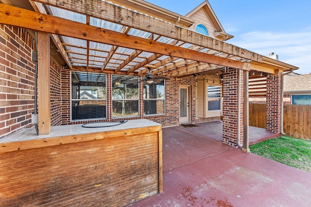 view of patio / terrace featuring ceiling fan and fence