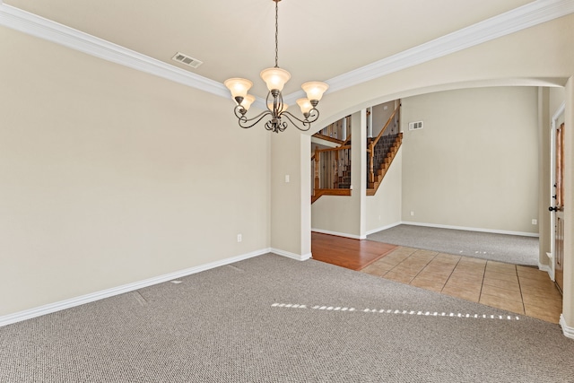 empty room featuring arched walkways, tile patterned flooring, visible vents, and an inviting chandelier