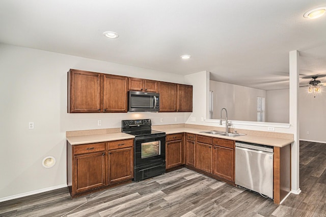 kitchen with brown cabinets, dark wood finished floors, stainless steel appliances, light countertops, and a sink