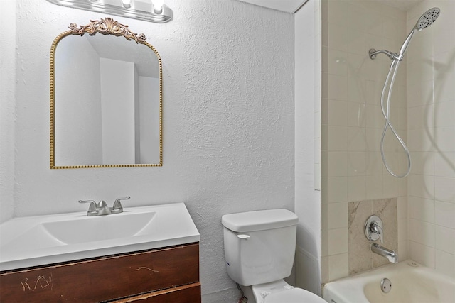 full bathroom featuring toilet, a textured wall, shower / tub combination, and vanity