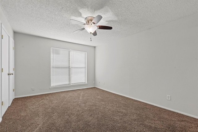 carpeted spare room featuring a textured ceiling, a ceiling fan, and baseboards