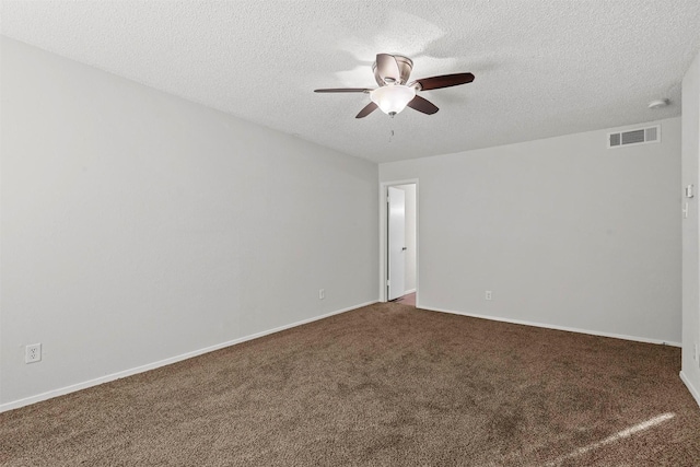 spare room featuring baseboards, visible vents, ceiling fan, a textured ceiling, and carpet floors