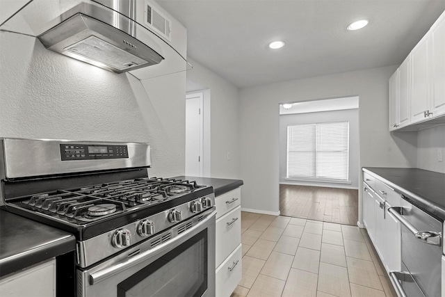 kitchen featuring dark countertops, stainless steel appliances, ventilation hood, white cabinetry, and recessed lighting