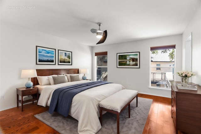 bedroom featuring dark wood-style floors, ceiling fan, and baseboards