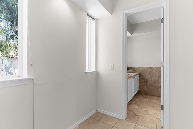 bathroom with tile patterned flooring, tile walls, and vanity