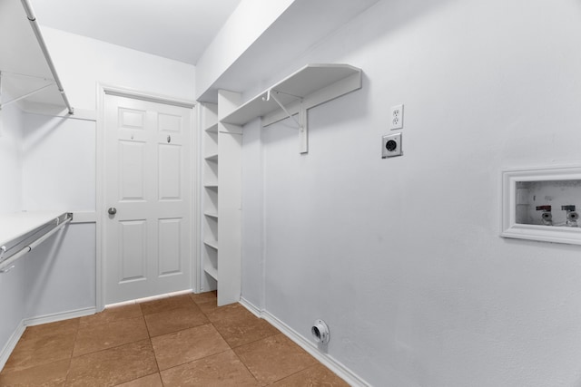 walk in closet with tile patterned flooring