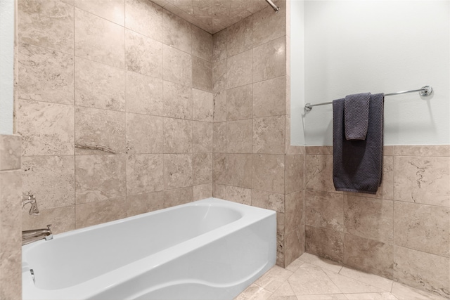 bathroom featuring a bath, tile walls, and tile patterned floors