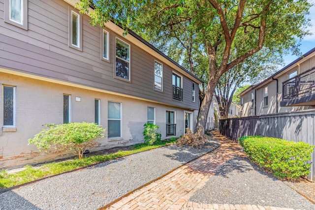 exterior space with fence and brick siding