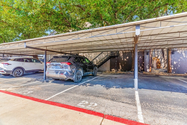 covered parking lot featuring stairs