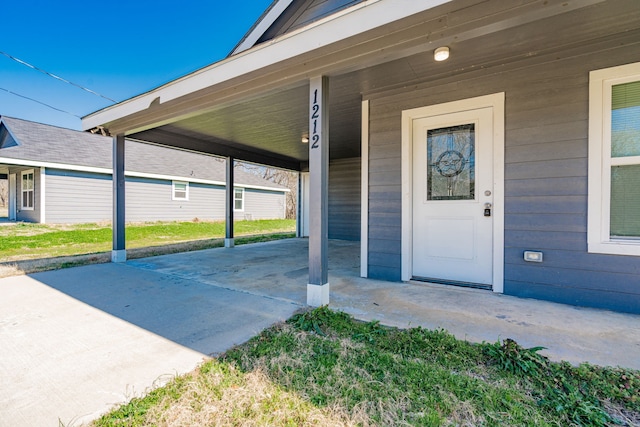 entrance to property featuring an attached carport