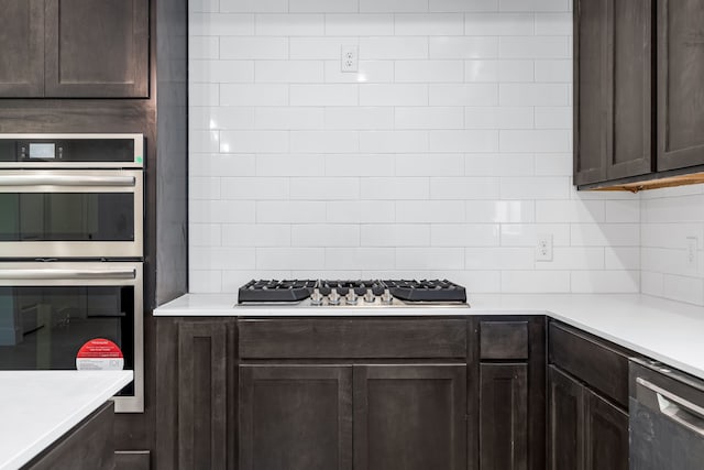 kitchen with light countertops, dark brown cabinets, decorative backsplash, and stainless steel appliances