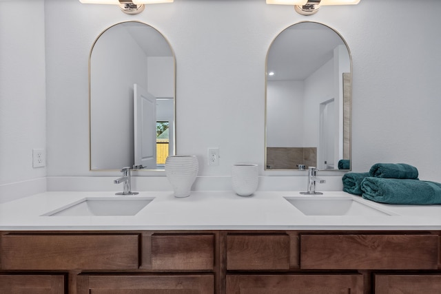 full bathroom with double vanity and a sink