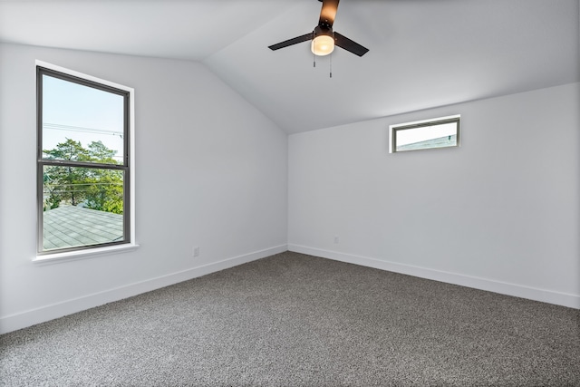 additional living space with vaulted ceiling, carpet flooring, a ceiling fan, and baseboards