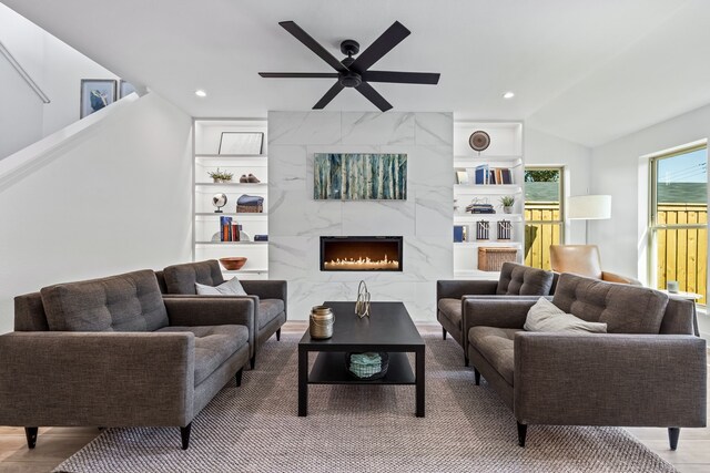 living room featuring recessed lighting, a fireplace, lofted ceiling, and ceiling fan
