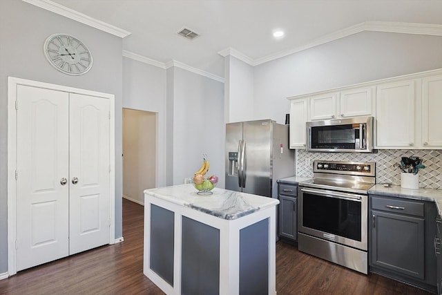 kitchen featuring visible vents, white cabinets, a kitchen island, gray cabinets, and stainless steel appliances