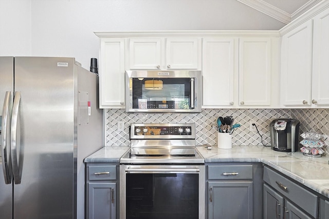 kitchen featuring appliances with stainless steel finishes, white cabinetry, backsplash, and gray cabinetry