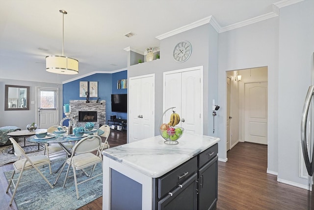 kitchen with visible vents, open floor plan, dark wood-type flooring, hanging light fixtures, and light countertops