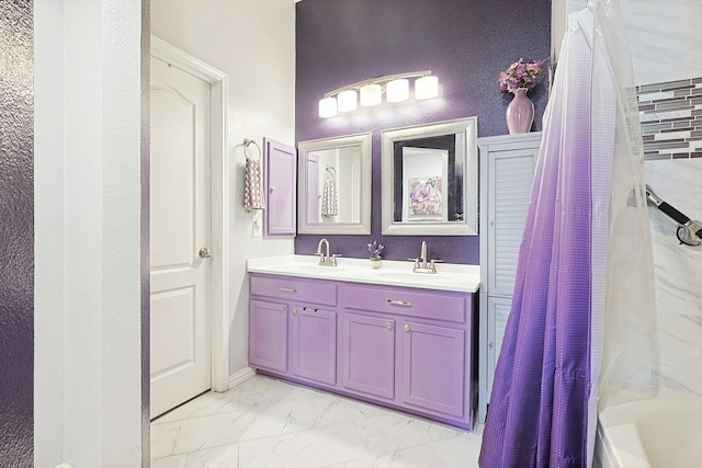 full bathroom featuring double vanity, marble finish floor, shower / tub combo, and a sink