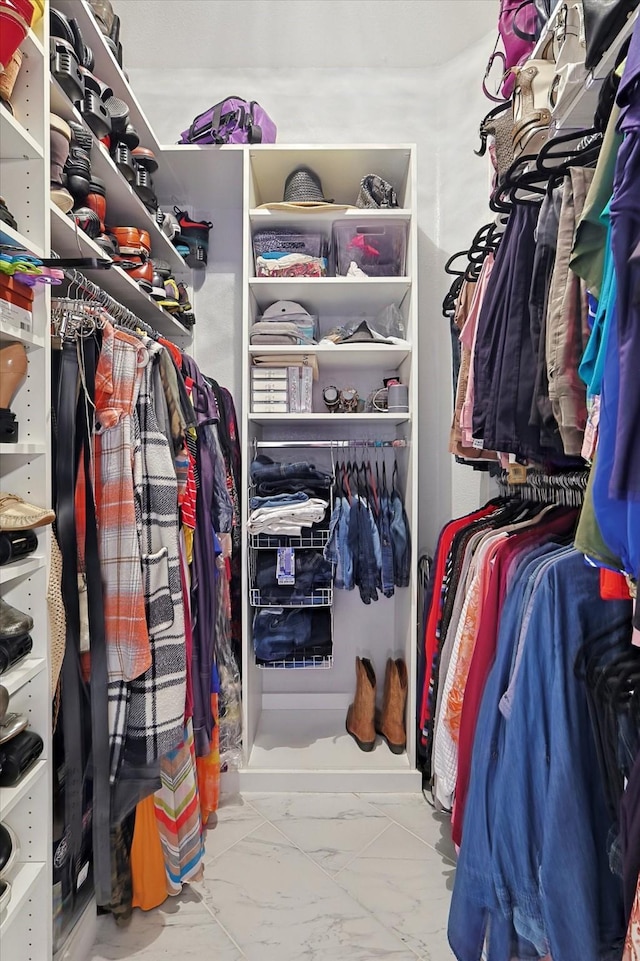 spacious closet featuring marble finish floor