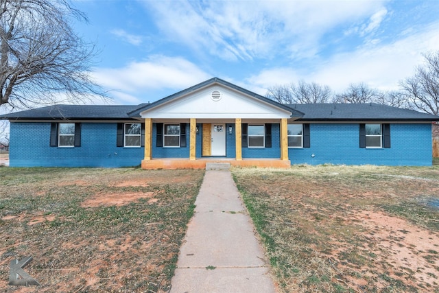 view of front of property with covered porch and brick siding