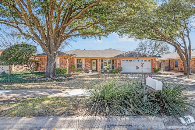 single story home with brick siding, driveway, and a garage